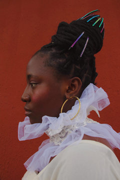 Profile of woman wearing ornate hairstyle and chiffon collar