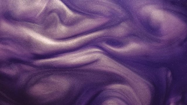 Paint fluid flow. Magic haze. Vertical glitter purple ink motion.