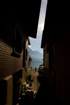 Rear view of boy in passage between houses
