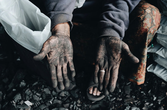 Hands of working miner