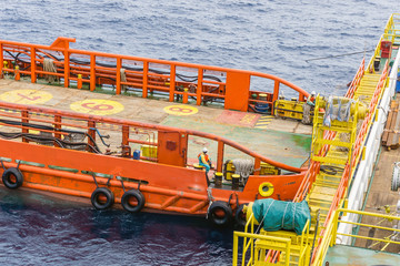 Anchor handling activities by a anchor handling tugboat for a construction barge at oil field