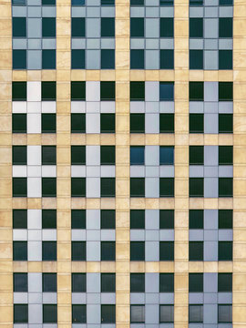 Grid of dark windows on highrise facade