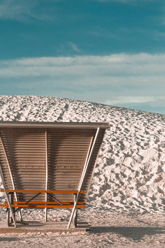 Empty strandkorb beach chair on beach