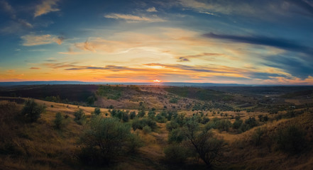 Naklejka na ściany i meble Soft autumn sunset panorama over countryside hills and valley. Beautiful rural landscape, nature scene.