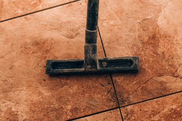 close-up. vacuum cleaner brush to vacuum tile. the next stage is the fugue