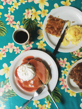 Overhead view of desserts on plates and coffee cup