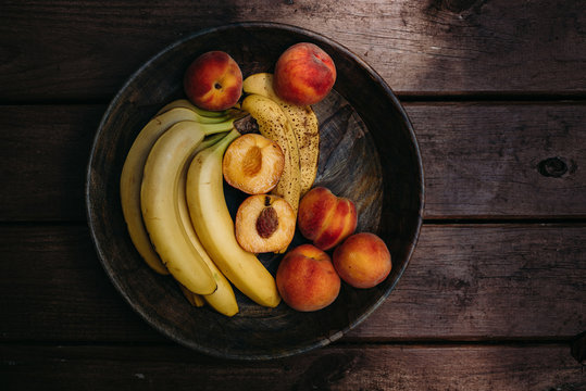 Overhead view of fruits bowl on wooden table