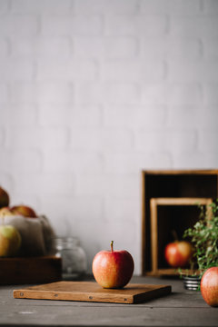 Selective focus of apple on wooden board