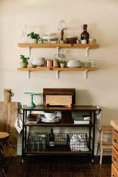 Kitchenware on wooden shelves and cart