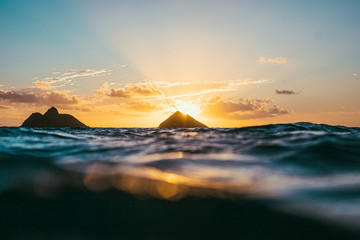 Islands surrounded by waves at sunset