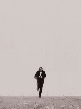 Black and white portrait of man buttoning blazer