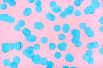 Obraz na płótnie Canvas Blue confetti on pink background.