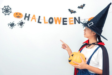 Asian girl witch costume playing in the room Happy Halloween Day 2019.