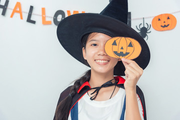 Asian girl witch costume playing in the room Happy Halloween Day 2019.