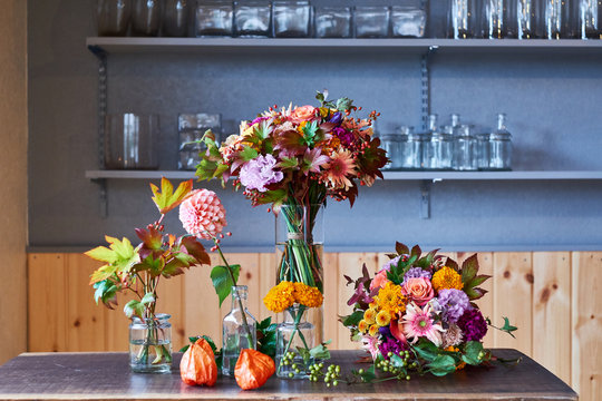 Bouquets arranged in glass vases on table