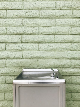 Drinking Fountain At Green Brick Wall