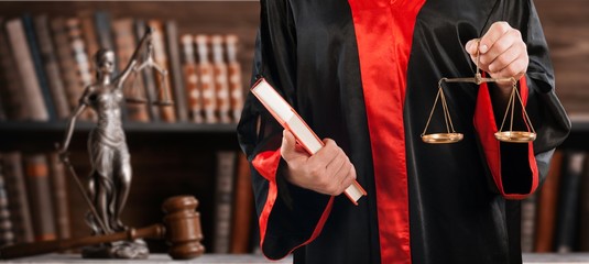 Man in black suit holding book