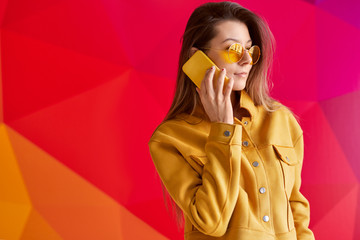 Trendy female talking on smartphone