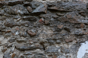 The old stone wall that having been done from granite stones