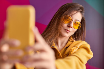 Trendy lady taking selfie