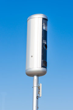 Traffic speed camera on a blue sky background preparing to use technology to stop speeding in cars on the road