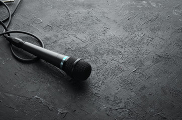 Microphone on black stone table. Studio. Top view. Free space for text. Copy space.