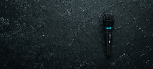 Microphone on black stone table. Studio. Top view. Free space for text. Copy space.