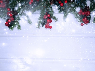 Obraz na płótnie Canvas christmas garland lights on fir branches on wooden background