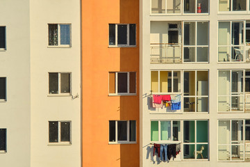 New building. Colorful clothes are hung on the balconies. close-up