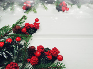 christmas decoration cones and garland lights on wooden background