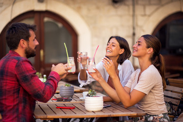 Happy friends talking and having fun at pub restaurant