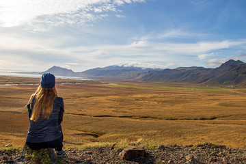 Fototapeta na wymiar Happy young traveler enjoys the nature of Iceland