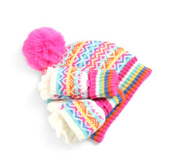 Warm knitted hat and mittens on white background, top view