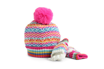 Warm knitted hat and mittens on white background
