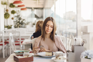 Teen girl eating dessert in cafe