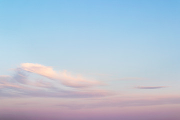 Obraz premium Sweet sky. Pink clouds in a blue sky at evening. Sky and clouds tranquil background with a pastel colors.