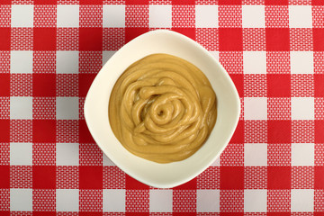 Mustard in bowl. Directly above.