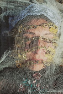 Close up of young woman covered in veil
