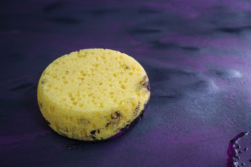 Sponge on Canvas Applying texture with black and purple paint.