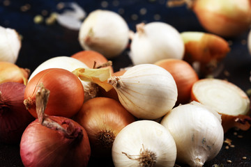different onions on rustic table