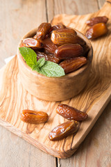 Dates palm fruit in wooden bowl is snack healthy..