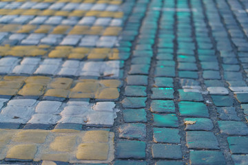 Naklejka premium Colorful pavement on the Moscow street. Pedestrian crosswalk in the sunset.