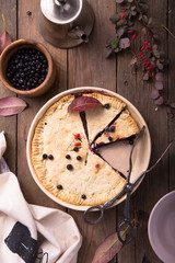 A traditional American blueberry pie on a light background. copy space