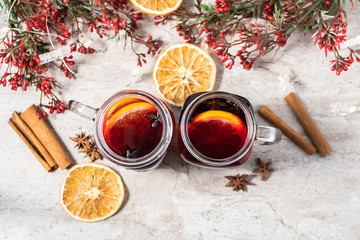 Traditional Christmas drink  Hot mulled wine in mason jars  with spices and fruits on the table.