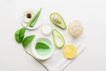 Natural aloe vera and avocado cosmetic. Handmade skin care products. Facial treatment preparation and skin refreshing cream background.  flat lay composition with natural cosmetic products.
