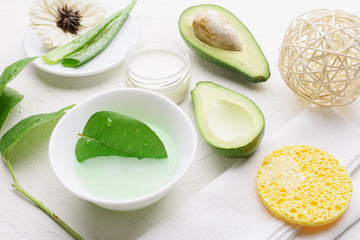 Natural aloe vera and avocado cosmetic. Handmade skin care products. Facial treatment preparation and skin refreshing cream background.  flat lay composition with natural cosmetic products.