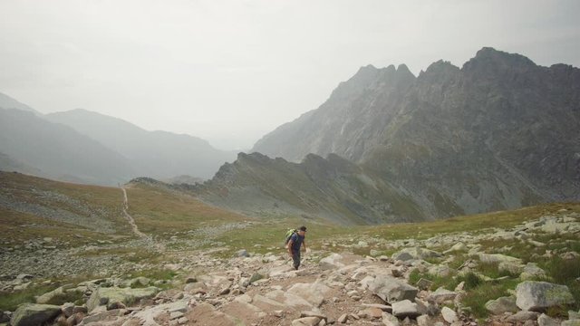 Hiker walking up the beautiful mountain and enjoying the view