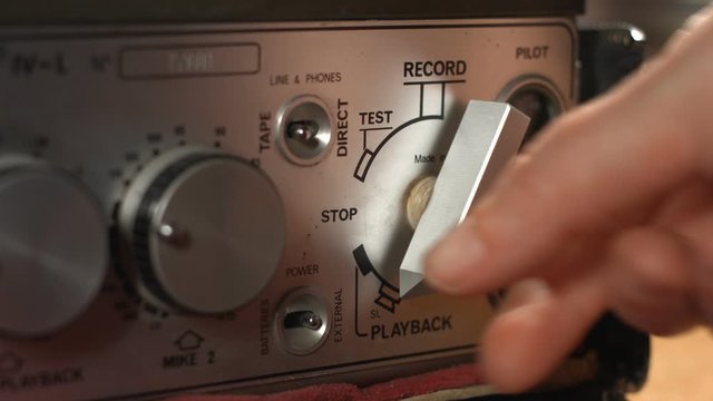 Turn on playback an old vintage professional sound tape recorder close up