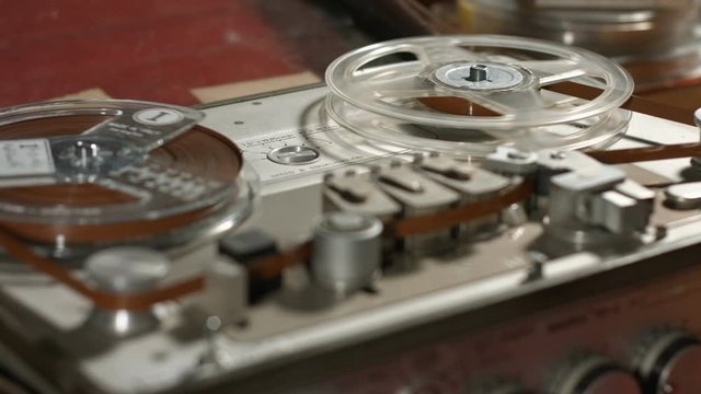 Tape on reel start running in an old vintage professional sound recorder