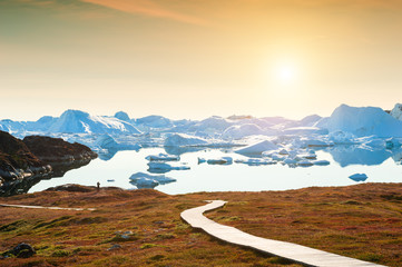 Hiking trail to the ice fjord in Ilulissat at sunset, western Greenland. Summer landscape © smallredgirl